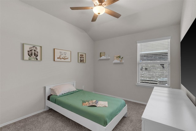 carpeted bedroom with baseboards, a ceiling fan, and vaulted ceiling