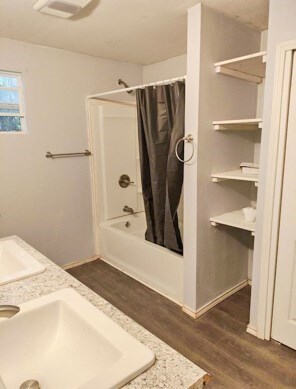 414 Future St, Palestine, TX 75801 - full bath with a sink, wood finished floors, and shower / tub combo with curtain