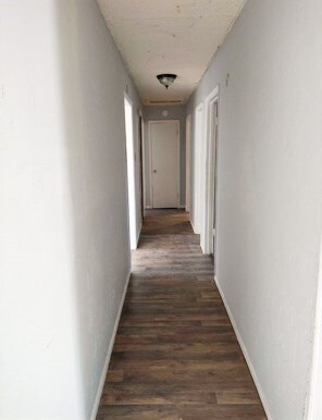 414 Future St, Palestine, TX 75801 - corridor featuring baseboards and dark wood finished floors