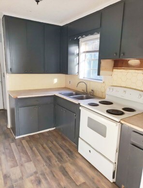 414 Future St, Palestine, TX 75801 - kitchen featuring dark wood-type flooring, a sink, electric range, and light countertops