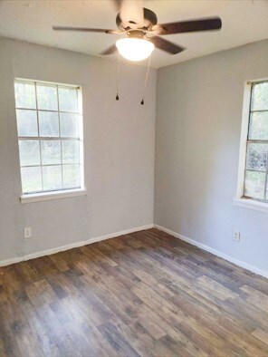414 Future St, Palestine, TX 75801 - spare room with baseboards, ceiling fan, and wood finished floors
