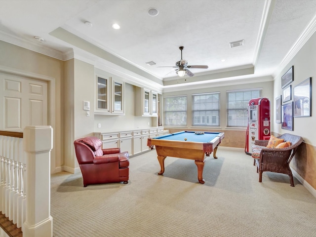 playroom featuring light colored carpet and a tray ceiling