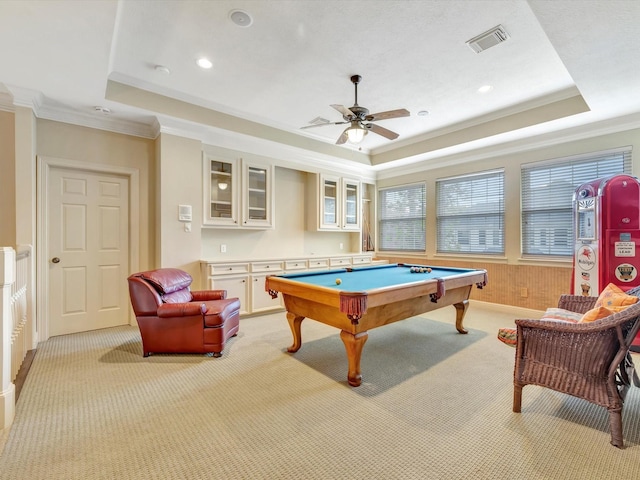 playroom featuring light colored carpet, crown molding, and a tray ceiling