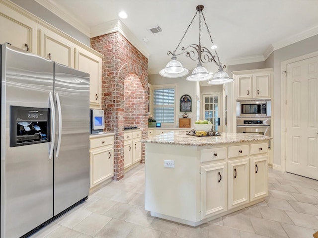 kitchen with light stone countertops, stainless steel appliances, light tile patterned floors, a center island, and visible vents