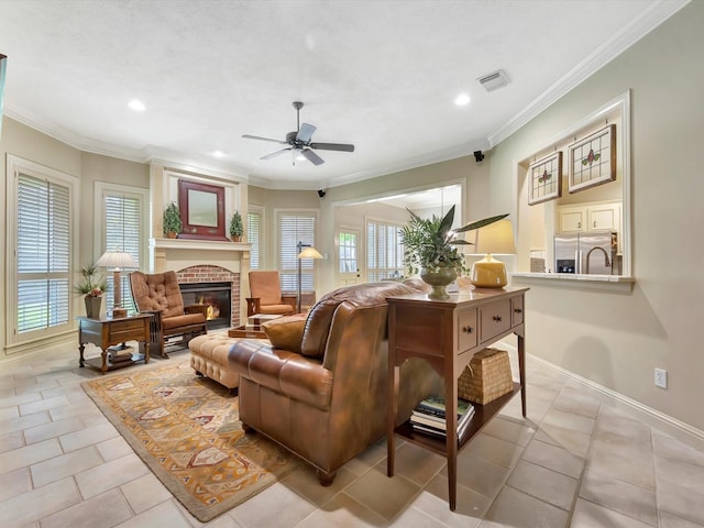 living area featuring crown molding, visible vents, recessed lighting, a fireplace, and a ceiling fan