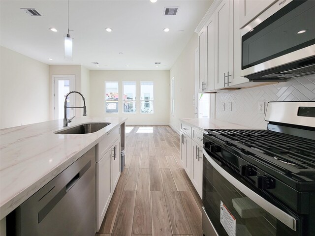 5931 Beall St A-B, Unit A-B Houston, TX 77091 - kitchen featuring recessed lighting, a sink, visible vents, light wood-style flooring, and appliances with stainless steel finishes