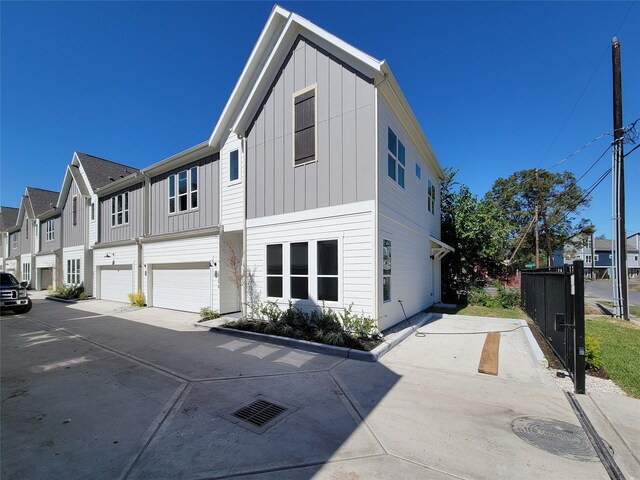 5931 Beall St A-B, Unit A-B Houston, TX 77091 - exterior space featuring concrete driveway, a residential view, an attached garage, and board and batten siding