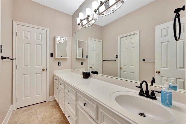 full bath featuring vanity, baseboards, and a notable chandelier