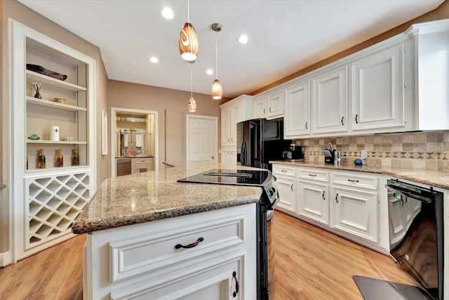 kitchen featuring white cabinetry, light wood-type flooring, black appliances, and a center island