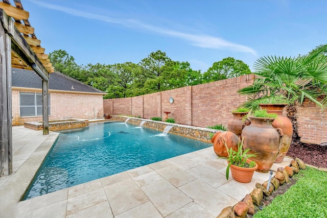 view of pool featuring a fenced backyard, a pool with connected hot tub, and a patio area