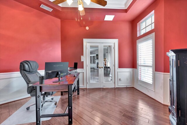 office featuring a ceiling fan, visible vents, french doors, and hardwood / wood-style flooring