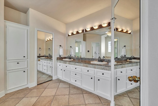 bathroom featuring a sink and double vanity