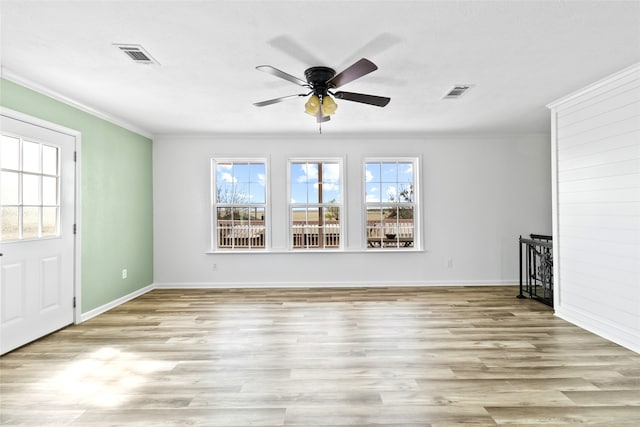 unfurnished living room with visible vents, wood finished floors, ceiling fan, and crown molding