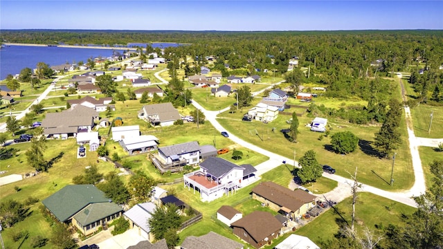 birds eye view of property with a water view, a forest view, and a residential view
