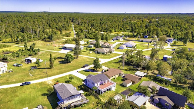 birds eye view of property with a view of trees and a residential view