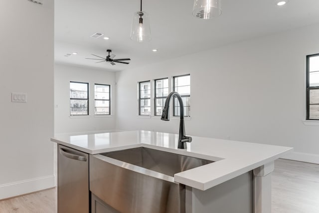 kitchen with plenty of natural light, light countertops, and a sink