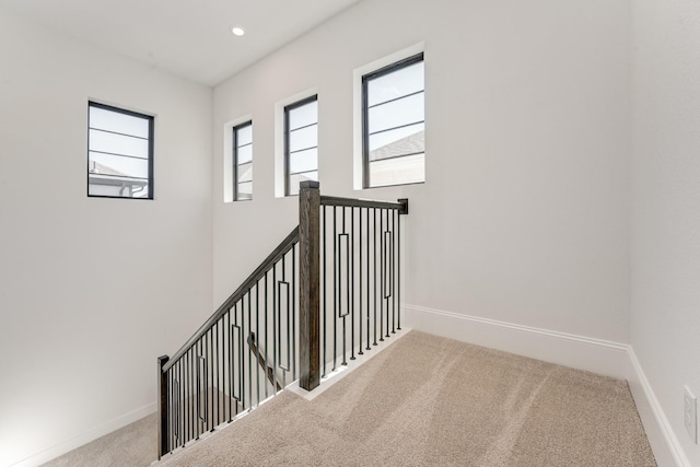 staircase featuring a healthy amount of sunlight, recessed lighting, carpet flooring, and baseboards