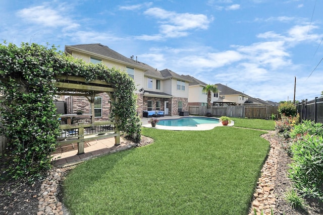 view of yard with a fenced in pool, a fenced backyard, and a patio area