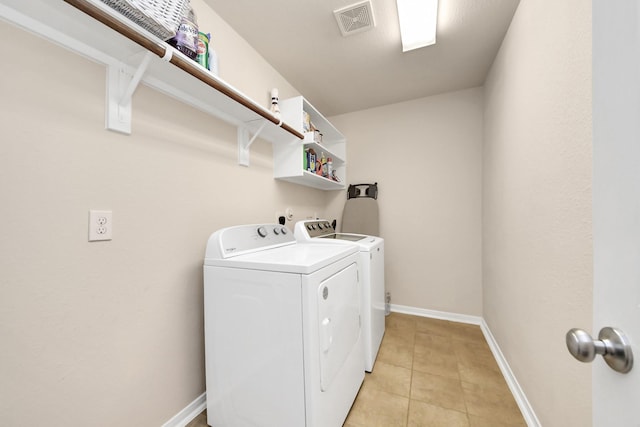 washroom with independent washer and dryer, laundry area, baseboards, light tile patterned floors, and visible vents