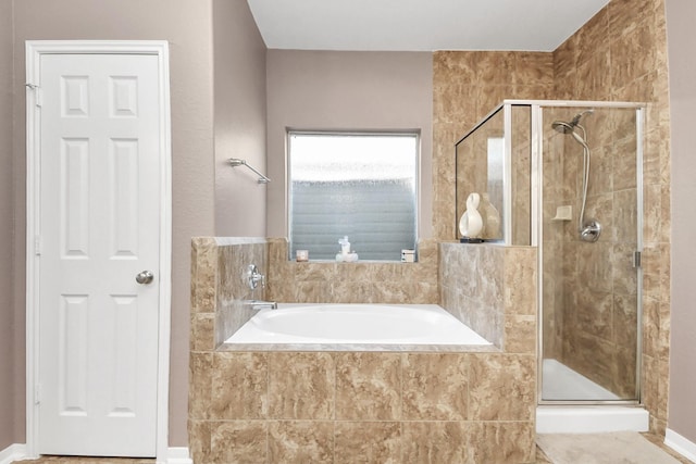 full bath featuring a stall shower and a garden tub