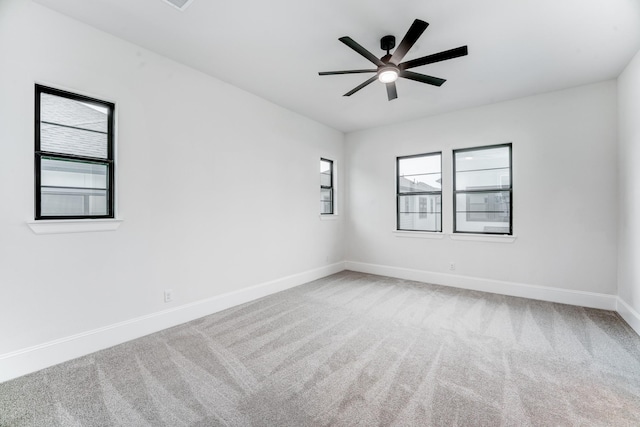 unfurnished room with carpet, ceiling fan, and baseboards