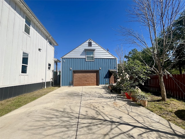 13505 Orleans St, Houston, TX 77015 - view of property exterior featuring board and batten siding, driveway, a garage, and an outdoor structure
