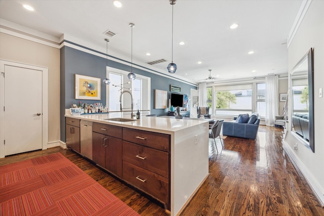 1946 Vermont St, Houston, TX 77019 - kitchen featuring a sink, a peninsula, light countertops, dark wood-type flooring, and ornamental molding