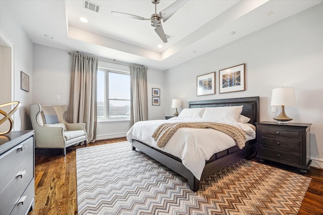 1946 Vermont St, Houston, TX 77019 - bedroom featuring wood finished floors, recessed lighting, a tray ceiling, a ceiling fan, and baseboards