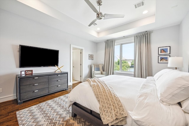 1946 Vermont St, Houston, TX 77019 - bedroom featuring a tray ceiling, dark wood-style floors, recessed lighting, ceiling fan, and baseboards