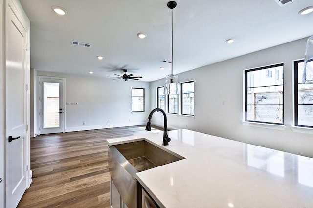 kitchen featuring recessed lighting, ceiling fan, hanging light fixtures, and dark wood-style flooring