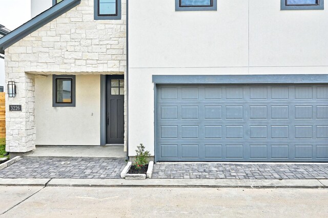 view of front of property with stone siding and stucco siding
