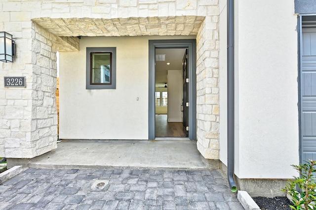 view of exterior entry featuring stone siding