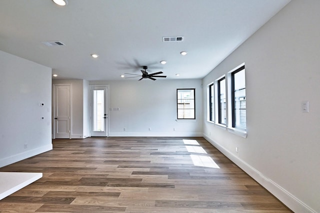 interior space with baseboards, visible vents, a ceiling fan, and recessed lighting
