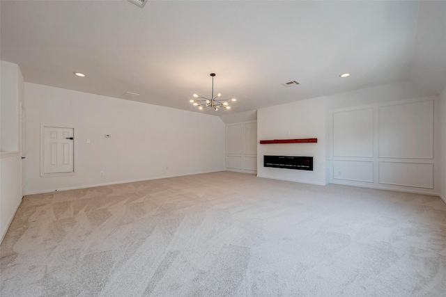 unfurnished living room with visible vents, recessed lighting, light carpet, and an inviting chandelier