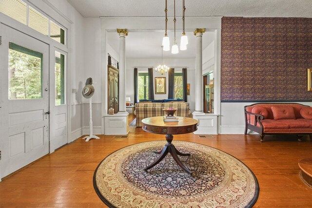 foyer entrance featuring a notable chandelier and wood finished floors