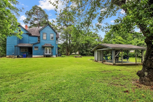 view of yard featuring a gazebo and french doors