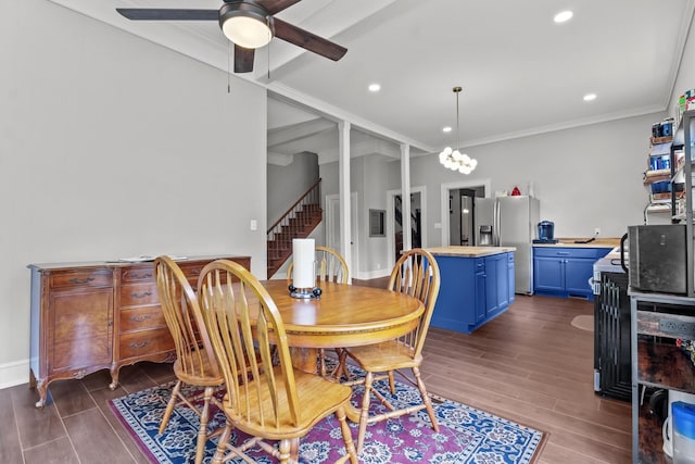 dining space with crown molding, dark wood-style flooring, recessed lighting, a ceiling fan, and stairs