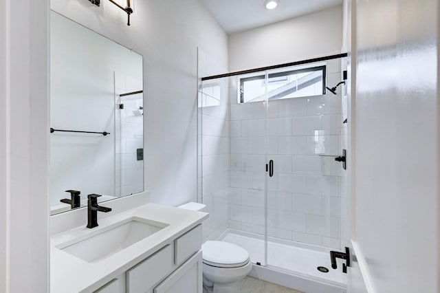 full bath featuring a shower stall, toilet, and vanity