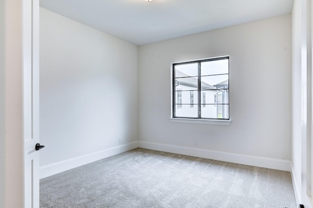 carpeted spare room with baseboards