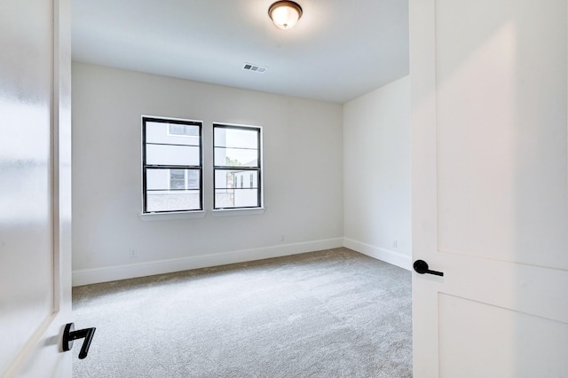carpeted empty room with baseboards and visible vents