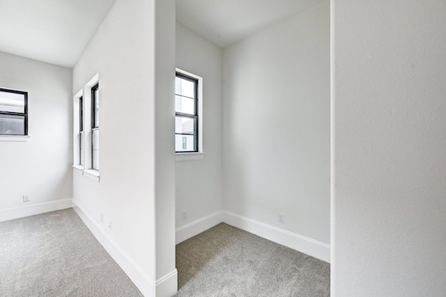 interior space with baseboards and carpet flooring