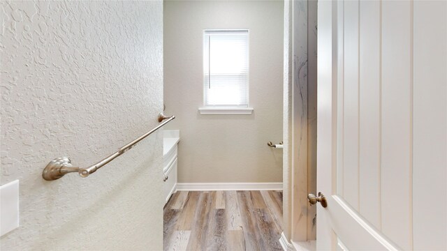walk in closet with light wood-style flooring
