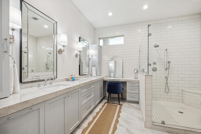 bathroom featuring double vanity, visible vents, marble finish floor, and a stall shower