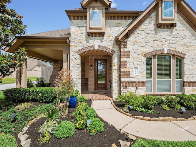 entrance to property with brick siding and stone siding