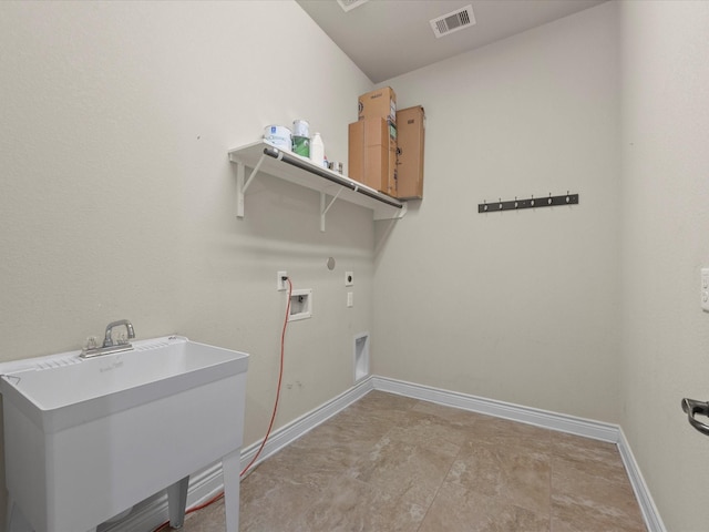 laundry area featuring a sink, baseboards, laundry area, and visible vents