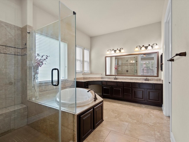 full bathroom featuring double vanity, a bath, a stall shower, a sink, and tile patterned floors