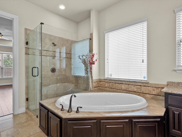 bathroom with vanity, tile patterned floors, a ceiling fan, a shower stall, and a bath