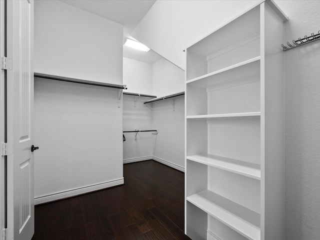 walk in closet with wood finished floors