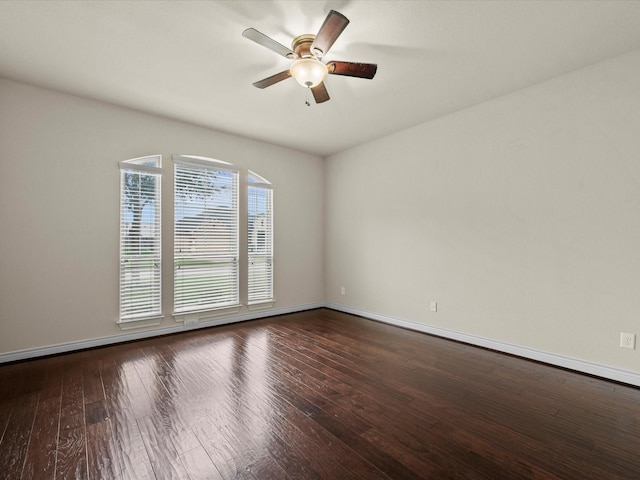 spare room with a ceiling fan, baseboards, and hardwood / wood-style floors