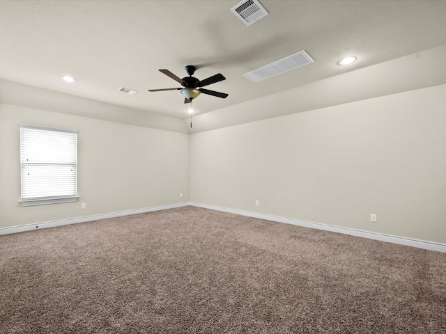 empty room with visible vents and carpet flooring